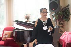 Woman standing in front of piano