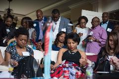 A group of people praying at an event